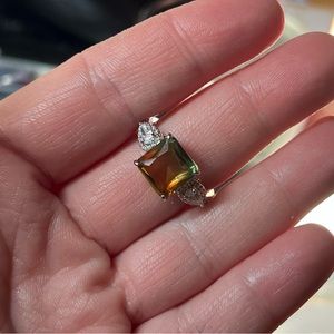 Size 9. Lab created lime bi color peridot on rhodium plating. SRP $136